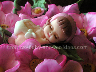 closeup of sleeping fondant baby in flowers