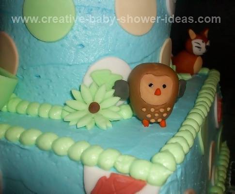 Closeup of forest friends baby cake showing owl and fox