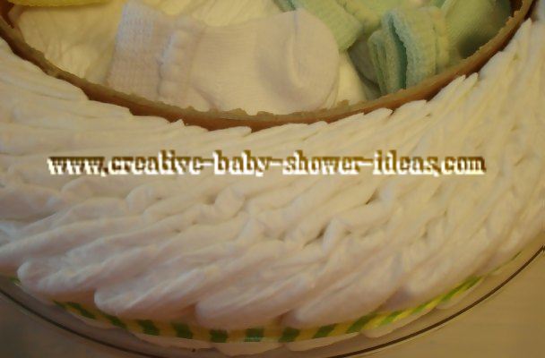 closeup of inside frog diaper cake showing baby supplies