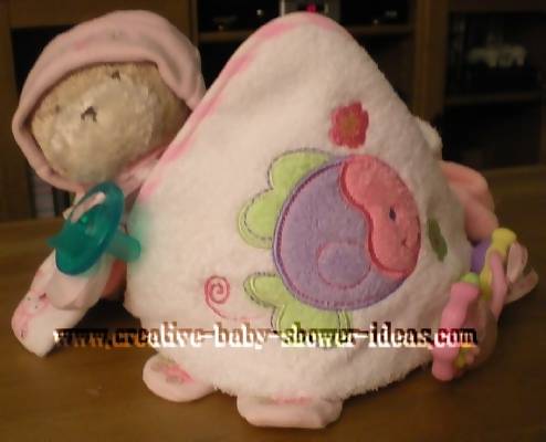 front of pink towel cupcake with teddy bear and pacifier