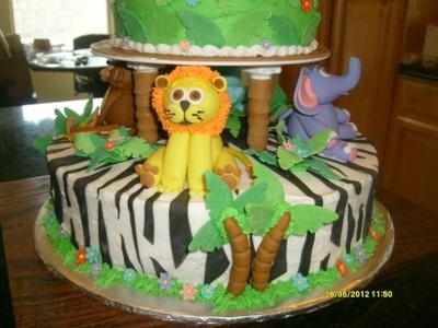 closeup of lion and elephant on white and black zebra stripe cake layer