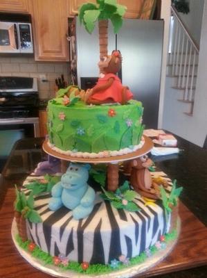 2 layer jungle animals baby shower cake with monkey and hippos