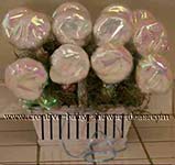 washcloth lollipops wrapped in irredescent paper and placed in basket as favors