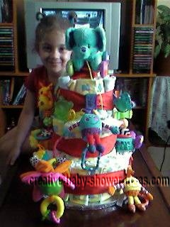 girl smiling by colorful animals diaper cake