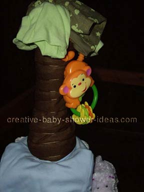 closeup of monkey hanging from diaper tree cake