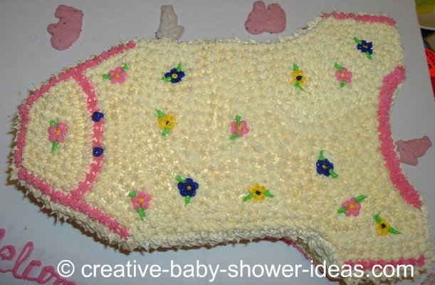 pink and blue flowers onesie cake