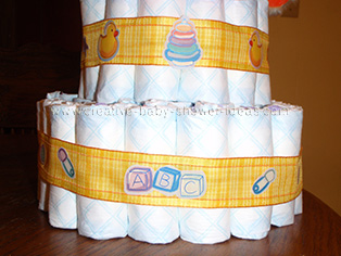 bottom layer of duck diaper cake showing plaid ribbon