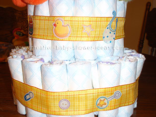 plaid ribbon with baby items for duck  diaper cake