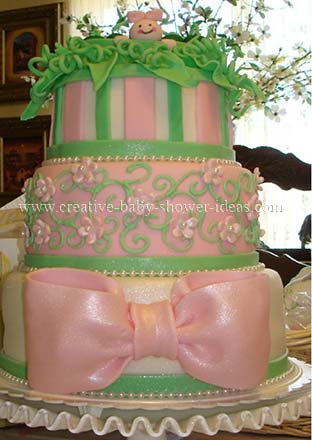 elegant cream pink and green pea in a pod cake with big pink bow in front
