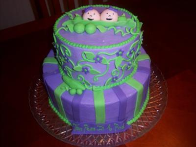 purple and green peas in a pod cake with smiling baby faces on top