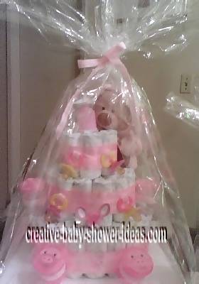 finished pink teddy bear diaper cake wrapped in cellophane