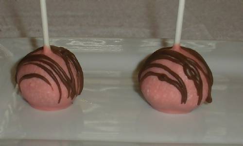 pink cake pops drizzled with chocolate