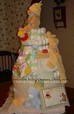 side view of winnie the pooh diaper cake showing baby pillow
