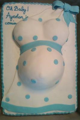 white and blue pregnant belly cake with dress draped on cake