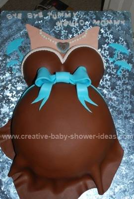 brown chocolate belly cake with teal bow