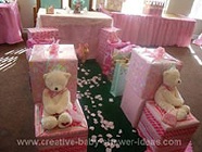 princess baby shower with lots of pink wrapped gifts and teddy bears