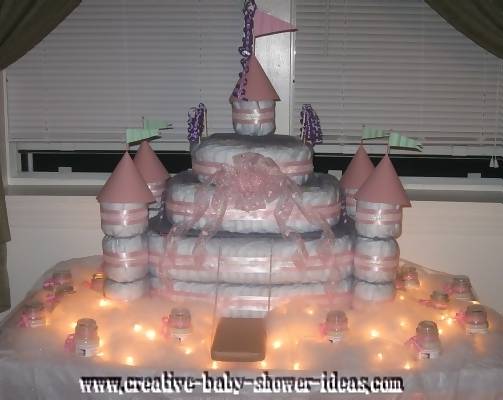 pink and white princess diaper cake with lights and candles