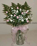 pink and white sock rose bouquet filled in with greenery and white baby's breath flowers