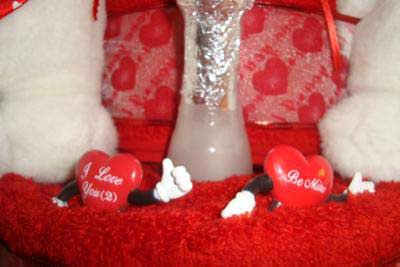 closeup of red towel cake layer with valentine goodies