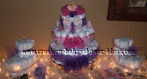baby shower display with 3 bootie cakes and tulle and christmas light decorations