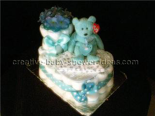 baby bootie cake with blue and white polka dot ribbon and teddy bear