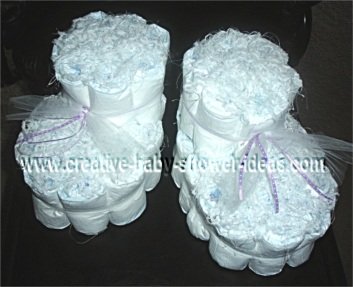 white baby bootie diaper cake with purple tulle