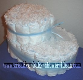 white baby bootie diaper cake tied with blue tulle