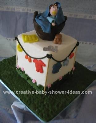 basket and baby with baby shower clothes cake