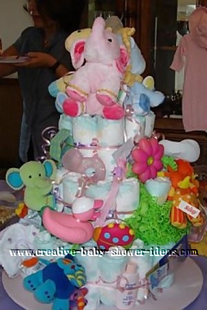 jungle diaper cake with lots of soft stuffed jungle animals attached