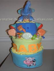 green and blue baby diaper cake with blue elephant on top and washcloth roses