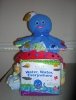 baby einstein themed diaper cake with blue octopus on top and book infront