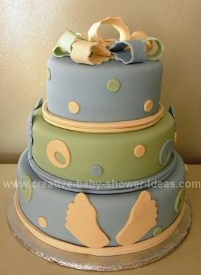 blue and green cake with baby footprints