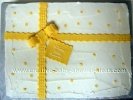 yellow and white polka dot present cake tied with a bow