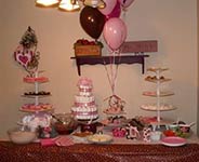 mod mom baby shower dessert table with pinks and browns and a diaper cake 