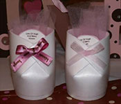 styrofoam cups cut and glued to create a baby bootie favor with treats inside