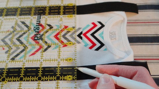 marking the sew line for the D ring on the onesies