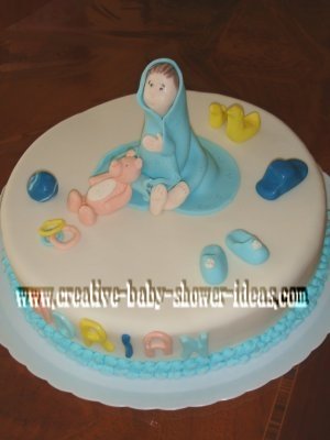 baby in a blue blanket cake