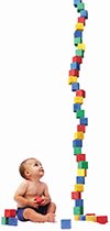 smart baby looking at a tall stack of blocks
