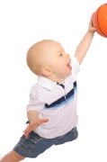 baby in the air shooting a basket with a basketball