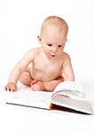 baby looking intently at book for answers