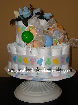 baby sock baby bootie cake on white cake stand