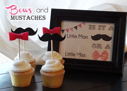 white cupcakes with pink bows and mustache lollipop decorations