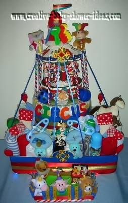 huge circus carousel diaper cake made of ribbon diapers and baby supplies