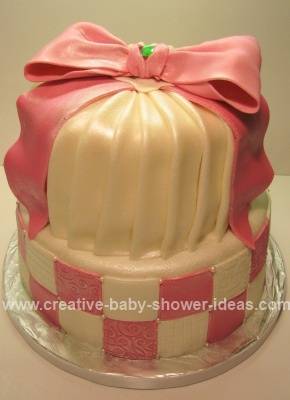 pink baby shower crown cake with emerald ston