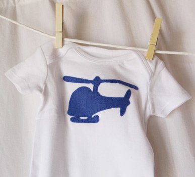 finished blue helicopter onesie hanging on clothesline