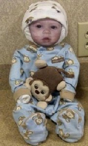 diaper baby in blue monkey pajamas and baby photo face
