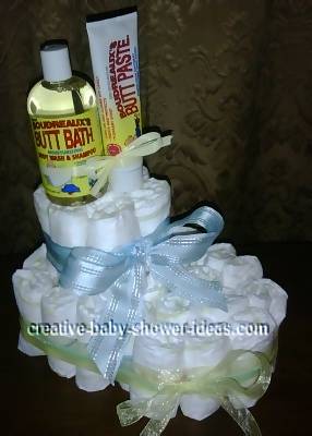 white diaper bootie with yellow and blue ribbons and bath supplies on top 