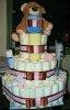 4 tier teddy bear diaper cake with brown and pink ribbon tied into bows
