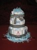 mod mom diaper cake with blue cream and grey striped ribbon and blue shredded paper