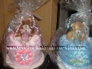 matching pink and blue twin diaper cakes with teddy bears on top